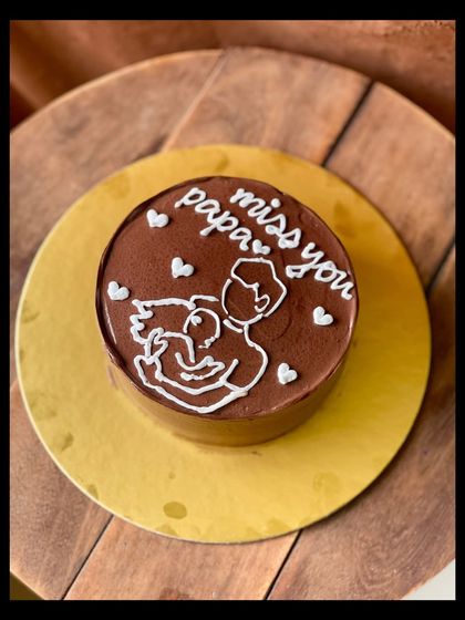 A touching and heartfelt cake with the message "miss you papa." The simple line drawing of a father and child makes this a deeply personal and meaningful cake.