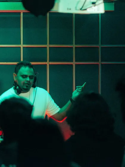 A silhouette shot of me gesturing to the crowd, taken from the dancefloor.