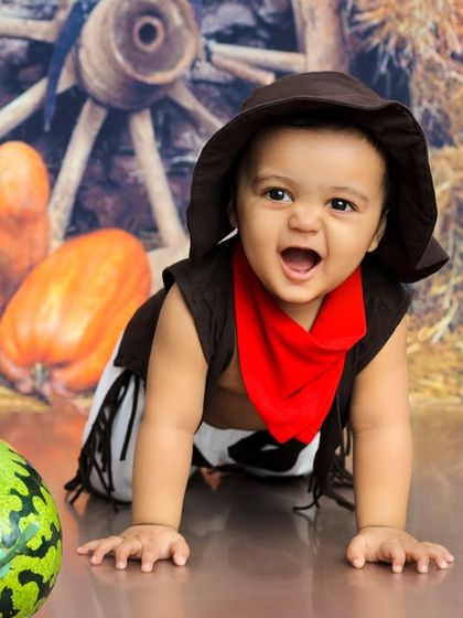 Howdy, partner. This little cowboy is ready for a wild west adventure, crawling through our rustic barn-themed set.