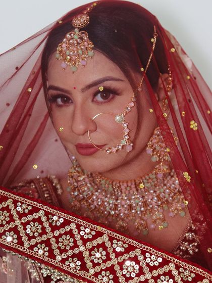 A confident bridal look. The makeup is bold yet elegant, designed to make the bride stand out on her special day.
