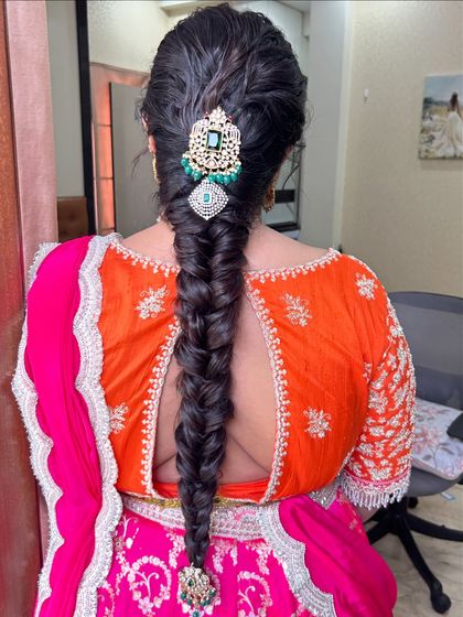 The full look of the fishtail braid with a statement jewellery piece, a great option for a wedding reception.