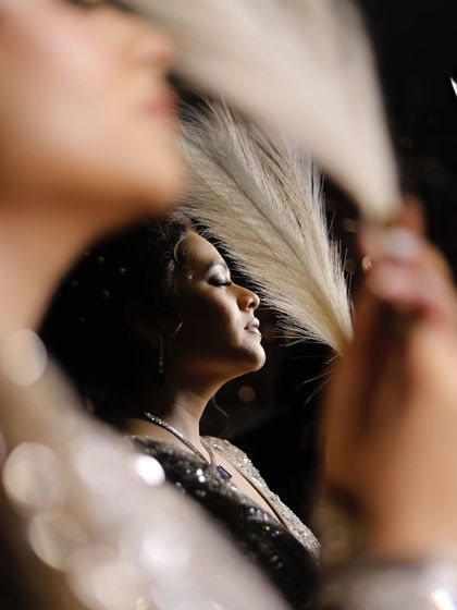 An artistic shot showing the reflection of the client. The makeup looks stunning from all angles.