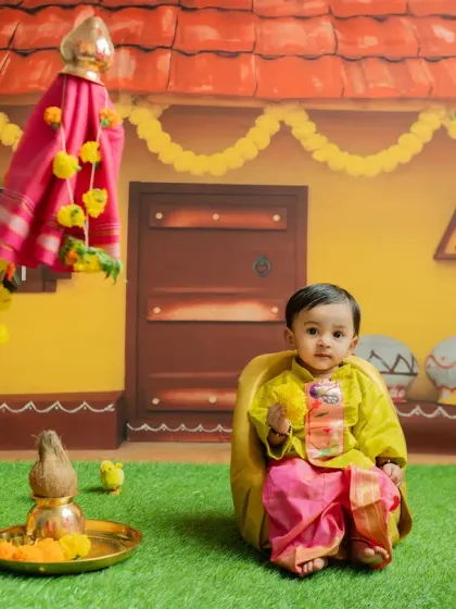 A sweet portrait for Gudi Padwa, with the baby holding a miniature 'gathi' (sugar crystal garland).