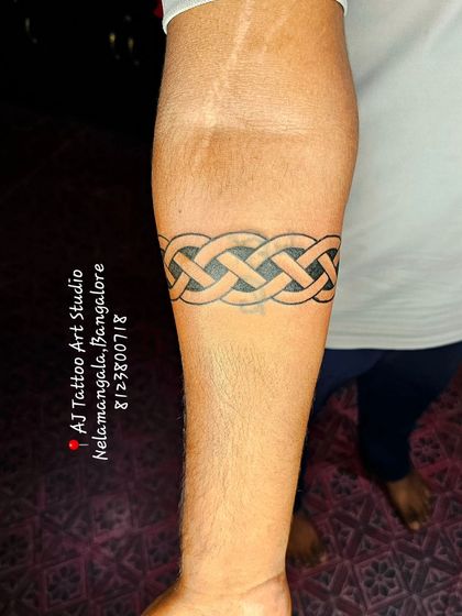 A finished Celtic knot armband, showcasing the clean and even line work.