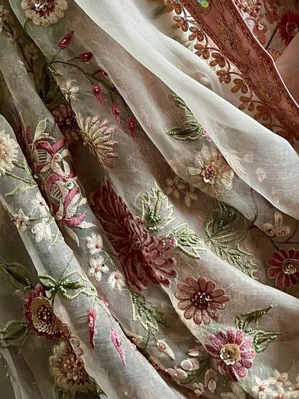A detail shot of the organza dupatta, showing the texture of the fabric and the floral embroidery.