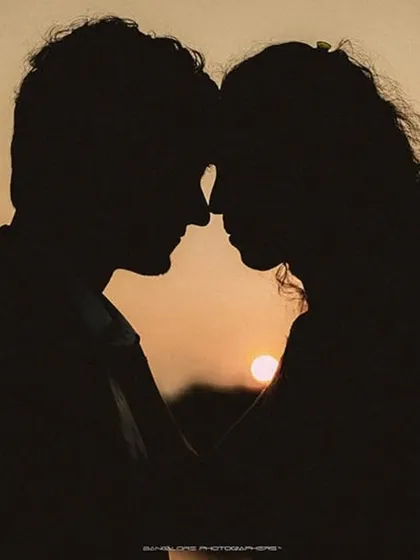 As the sun dips below the horizon, it paints the perfect silhouette of two people completely lost in their own world. This shot is all about the quiet connection, the unspoken promises, and the simple beauty of being together against a dramatic natural canvas.