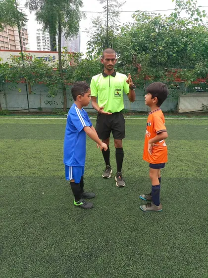 A handshake between two young captains, a great display of sportsmanship before the game begins.