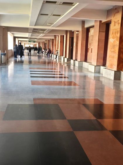 The impressive corridors of the Lucknow High Court. The atmosphere is bustling yet disciplined, a perfect embodiment of the legal world.
