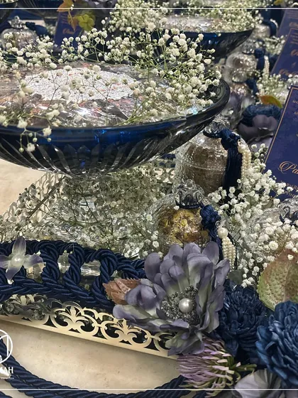 The Azure Crystal Bowl, here paired with ornate jars instead of potlis. This demonstrates the versatility of our hamper designs, allowing for customization based on the client's preference for their wedding favors.