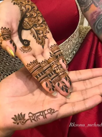 A beautiful symbol of togetherness, this design was for a couple who wanted to share the experience. I created a graceful peacock design for her and inscribed her name on his hand, a simple yet powerful expression of their bond.