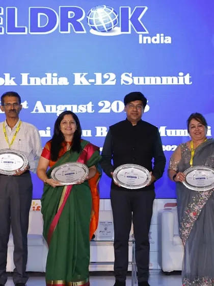 A group of education leaders holding their awards at the Eldrok Mumbai Summit. This image represents a collective effort to advance the quality and scope of K-12 education in India.