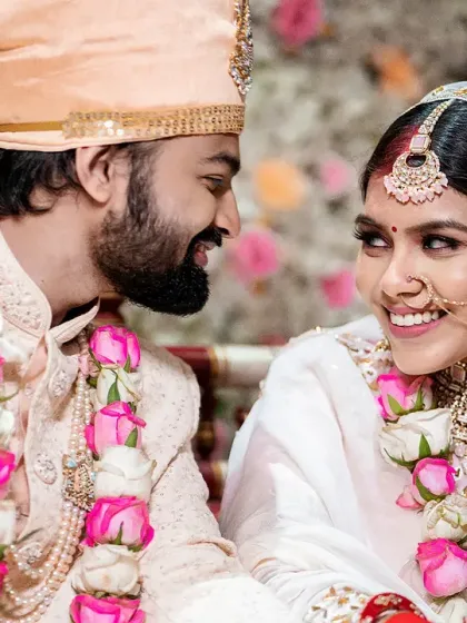 A beautiful, candid moment during the wedding ceremony. The genuine smiles and eye contact between the bride and groom are what make these photos so special.