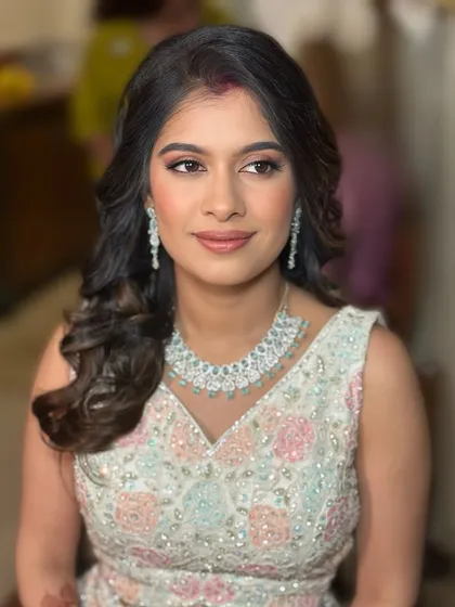 Soft, radiant, and camera-ready. This engagement look features a pastel lehenga paired with a luminous makeup base, soft smokey eyes, and a neutral lip, creating a look of pure elegance for the modern bride.