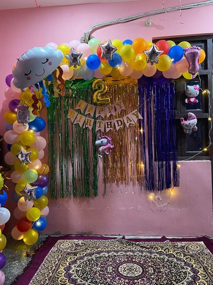 A wider shot of the second birthday home decoration, showing how the arch and backdrop create a perfect party corner.