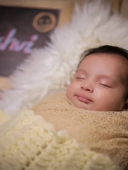 A close-up portrait of a sleeping newborn, Kaashvi, highlighting her peaceful expression and delicate features.