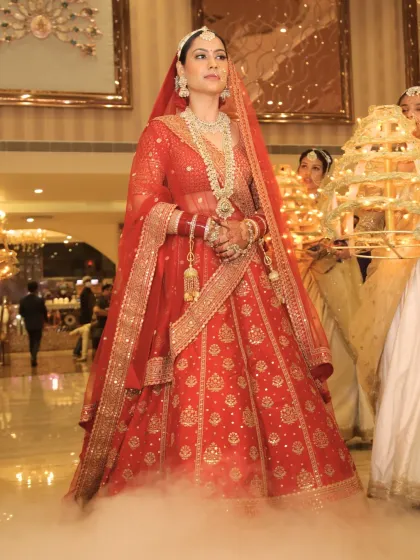 The bride's grand entrance, complete with dramatic smoke. Her makeup remains flawless and radiant, designed to look magical in every moment and every photograph.