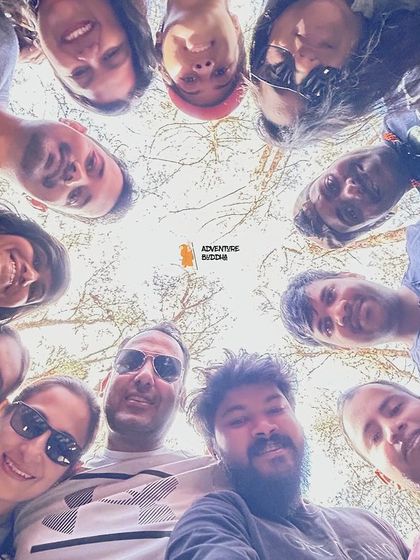 A low-angle group selfie, a classic shot that captures the fun and unity of our travel groups.