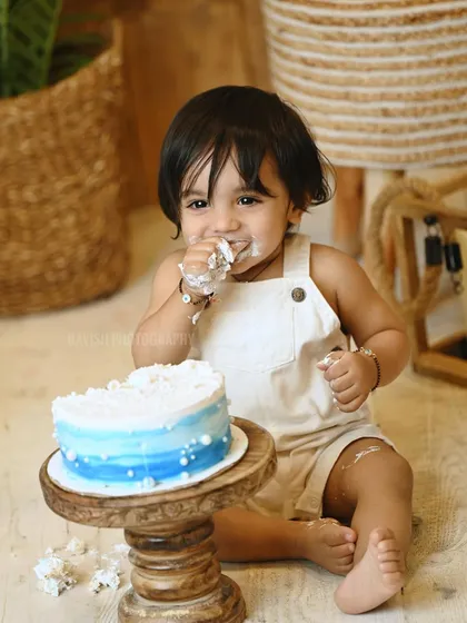 An adorable moment of the baby enjoying his birthday cake.