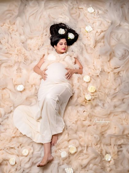 A duplicate of 112, this creative "bed of clouds" shot is a beautiful way to capture the dreamy and peaceful state of awaiting your little one.