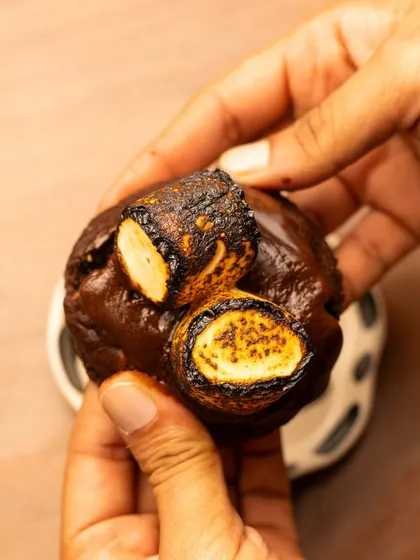 This shot shows the s'mores cookie being picked up, giving a sense of scale and making it feel more interactive and tempting for the viewer.
