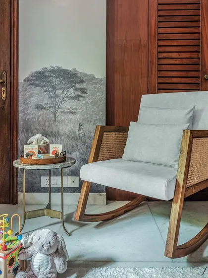 A comfortable rocking chair is a must-have in any nursery. I chose this wood and cane design to complement the room's furniture, creating the perfect spot for feeding and cuddling.