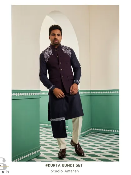 For an evening of elegance, we present this space blue bundi set. The deep tones of the bundi and kurta are highlighted by striking silver handwork on the shoulder and drape, a design made for engagements and cocktail parties.