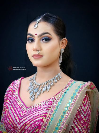 Embracing moody and dramatic vibes with this deep blue smokey eye. Paired with a vibrant pink lehenga, this look is for the woman who wants to make a bold statement.