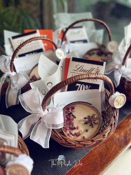 A collection of curated mini-hampers ready for delivery. The consistent styling with white ribbons and wax seals ensures that even in a bulk order, each gift feels individually crafted and special.