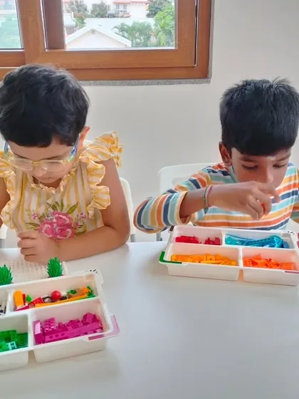 Two young students at our Whitefield branch are engrossed in their LEGO project, sorting pieces and building together.
