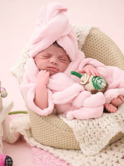 Another take on our spa day theme, this baby is wrapped in a pink towel and robe, surrounded by pearls and other fun, pampering props.
