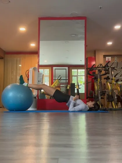 Hamstring curls on a stability ball. This exercise strengthens the hamstrings and glutes while also challenging your core stability.