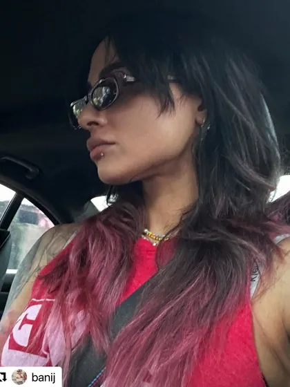 The incredibly cool Bani J rocking a long shag haircut I created for her. This picture shows how the style evolved with a fun pink and purple color melt.