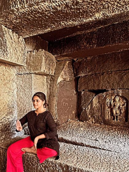 A moment of quiet contemplation inside a cave temple during Navratri. The nine nights of Navratri are a special time for devotion and dance, celebrating the different forms of the goddess Durga.
