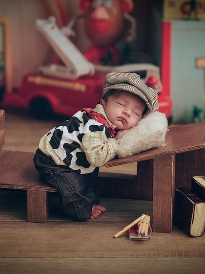 To infinity and beyond. A wider shot of our Toy Story inspired theme, showing the baby sleeping on a miniature bed in a room full of vintage toys.