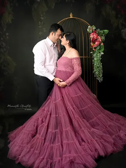 A tender moment between the expecting couple. Set against a floral backdrop with the birdcage prop, this image feels both romantic and timeless.