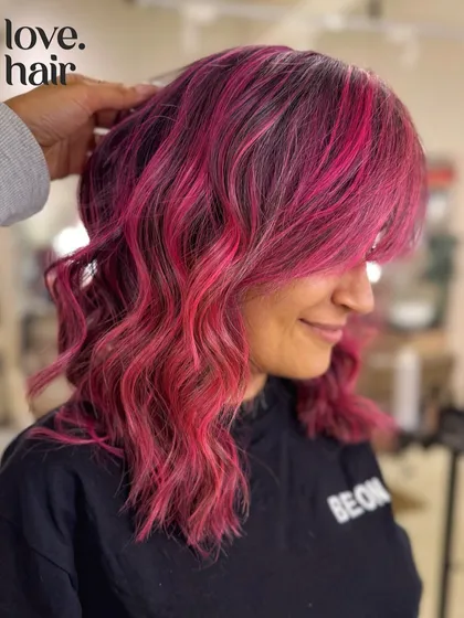 A close-up of the pink balayage, showing the soft waves and beautiful color blend.