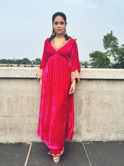 A pop of pink for Nushrratt Bharuccha in Ahmedabad. This velvet maxi dress with embellished cuffs is a comfortable yet glamorous choice for travel and promotional events.
