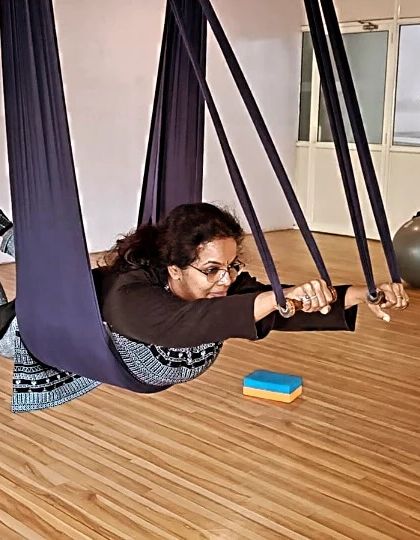 Flying like a superhero! This playful pose, supported by the aerial hammock, is not only fun but also a great way to engage the core and back muscles.