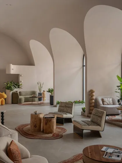 A wide perspective showing how the large arched windows flood the space with natural light, enhancing the architectural curves.