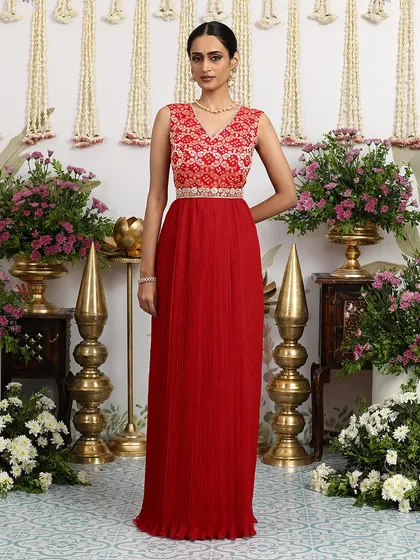 A lightweight Bandhani dress in a vibrant red, crafted for intimate soirées and pre-wedding festivities. The pleated skirt and embellished yoke create a look of effortless grace.