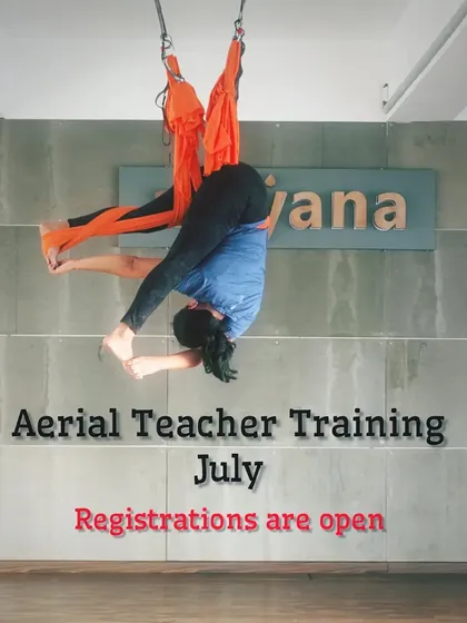 An announcement for our July aerial teacher training, featuring an instructor in a deep inverted pose.
