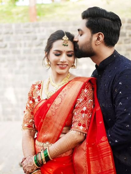 A tender forehead kiss, a classic romantic pose for an engagement photoshoot.