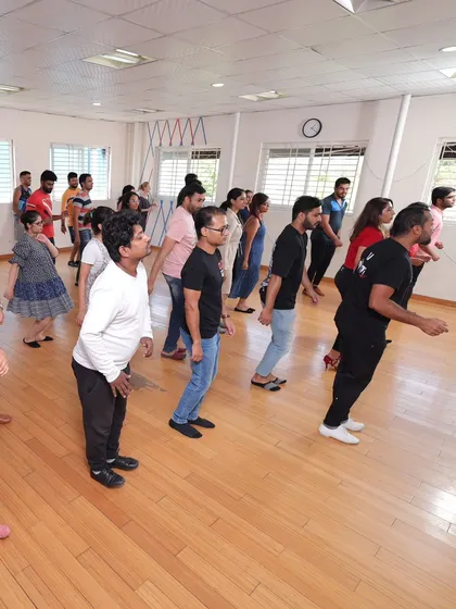 A full class of beginners learning their first footwork patterns. We start with the basics to build a strong foundation, ensuring everyone feels confident before they start dancing with a partner.