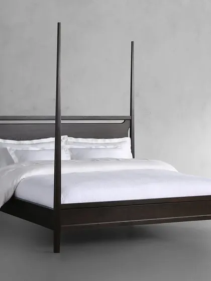 Our Brooklyn Bed, a modern take on the classic four-poster. Handcrafted by Indian artisans from solid ash wood, this bed is stained and sealed by hand to achieve a rich ebony color, with a clear lacquer topcoat for protection and a subtle sheen.