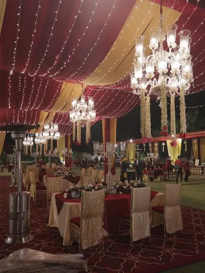 For outdoor evening weddings, I use a combination of elegant tenting, fairy lights, and crystal chandeliers to create a magical, starlit effect while ensuring guest comfort with heaters.