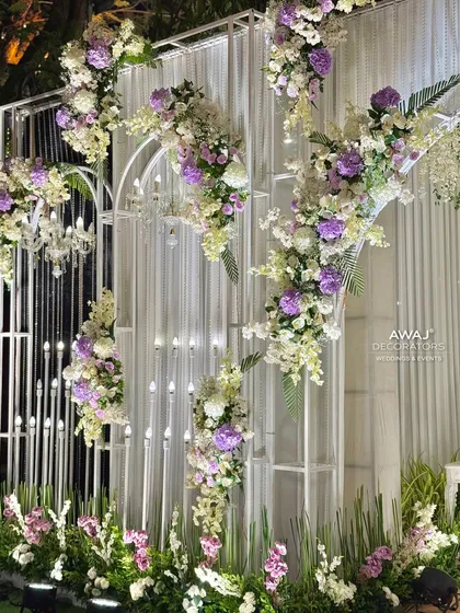 A close-up of the entrance wall, showing the beautiful floral arrangements and candle-like lighting fixtures.