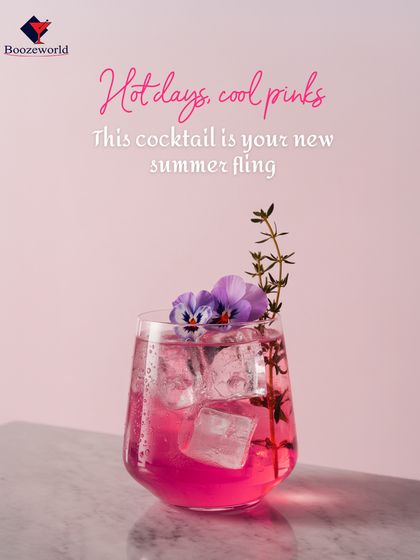 Pretty in pink, this summer cocktail is garnished with edible flowers and a sprig of thyme. The delicate floral and herbal notes make it a sophisticated and refreshing choice for warm days.