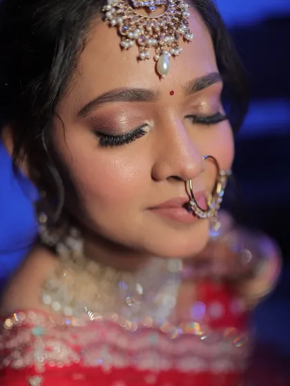 A detailed shot of the bride's eye makeup, featuring soft pink and brown tones.