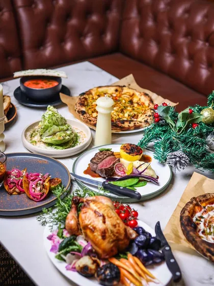 A festive spread for a special event. This table includes our roast chicken, steak, tacos, and salads, showing the variety I can bring to your party.