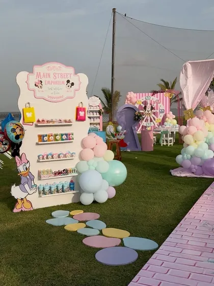 A 'Main Street Emporium' stand for party favors. This is a creative and organized way to display return gifts for the little guests.